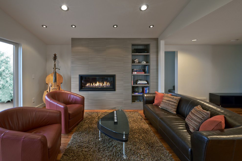 Photo of a contemporary living room in Seattle with white walls, medium hardwood floors, a ribbon fireplace and no tv.