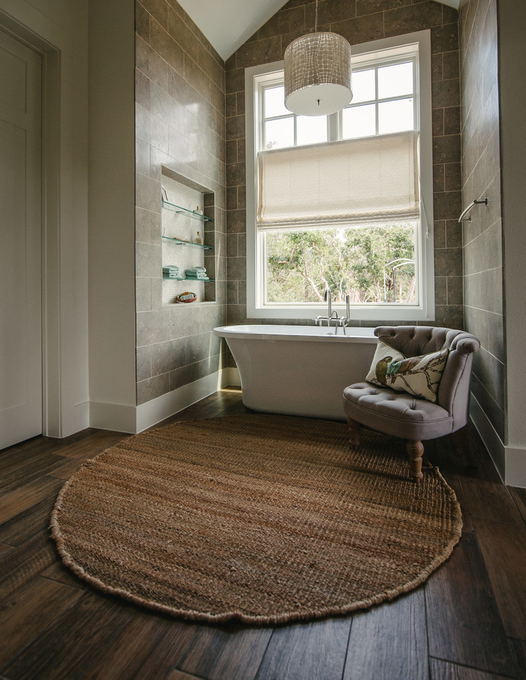 Design ideas for a transitional bathroom in Austin with a freestanding tub, limestone and a niche.