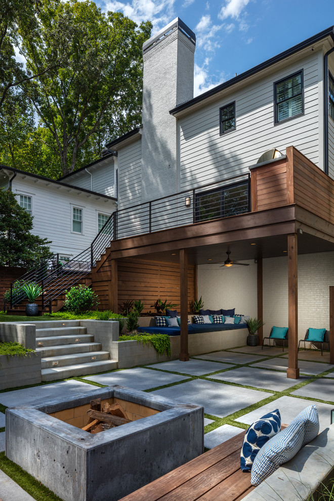 This is an example of a large contemporary backyard deck in Atlanta with a pergola.