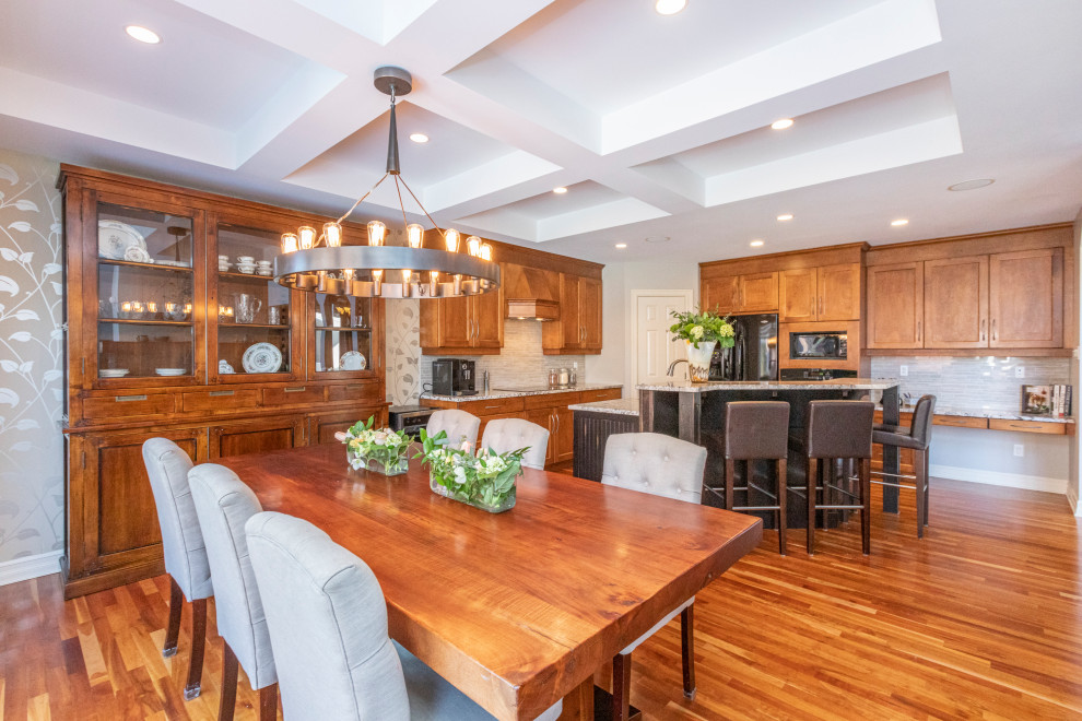 Inspiration for a large transitional medium tone wood floor kitchen remodel in Ottawa with shaker cabinets, medium tone wood cabinets, granite countertops, gray backsplash, mosaic tile backsplash, stainless steel appliances and an island
