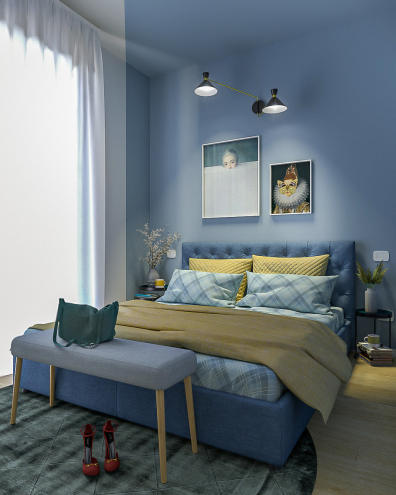 Cette photo montre une petite chambre parentale tendance avec un mur bleu et parquet clair.
