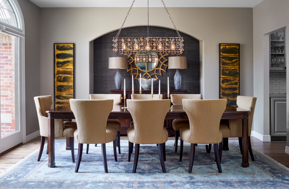 Inspiration for a mid-sized transitional medium tone wood floor and brown floor enclosed dining room remodel in Denver with gray walls and no fireplace