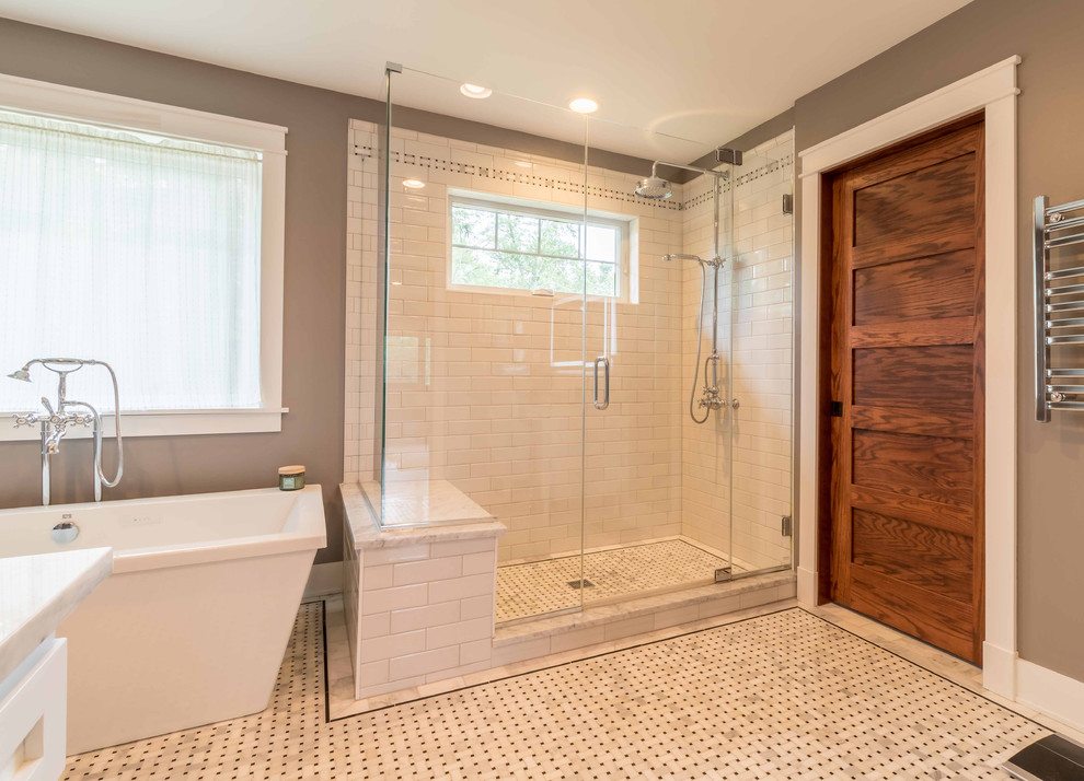 Mid-sized arts and crafts master bathroom in Chicago with shaker cabinets, white cabinets, a freestanding tub, a two-piece toilet, black and white tile, subway tile, grey walls, marble floors, an undermount sink, marble benchtops, white floor, a hinged shower door, white benchtops, an alcove shower, a shower seat, a double vanity, a freestanding vanity, wallpaper and wallpaper.