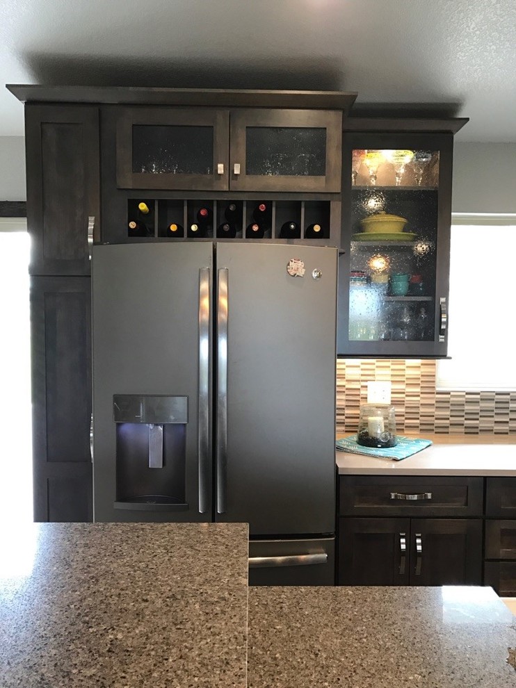Inspiration for a mid-sized transitional single-wall light wood floor open concept kitchen remodel with shaker cabinets, dark wood cabinets, multicolored backsplash, glass tile backsplash, stainless steel appliances, an island, a farmhouse sink and granite countertops