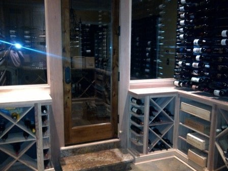 This is an example of a mid-sized contemporary wine cellar in Nashville with slate floors and storage racks.