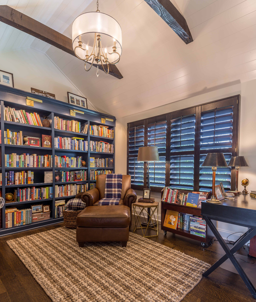 Inspiration for a mid-sized traditional home office in Chicago with a library, white walls, dark hardwood floors, a freestanding desk, brown floor, exposed beam, no fireplace, a brick fireplace surround and wallpaper.