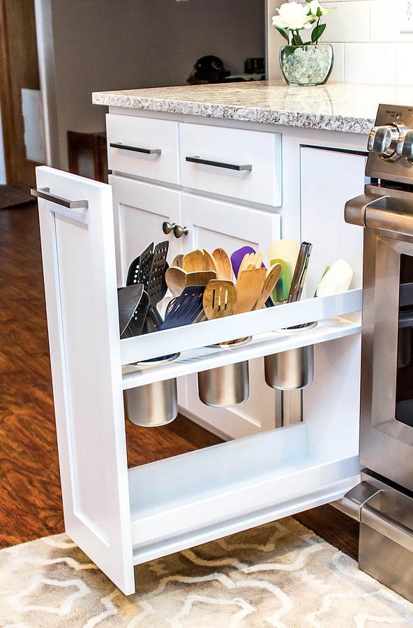 Large transitional galley medium tone wood floor and brown floor enclosed kitchen photo with an undermount sink, white cabinets, quartzite countertops, white backsplash, stainless steel appliances, shaker cabinets, ceramic backsplash, a peninsula and multicolored countertops