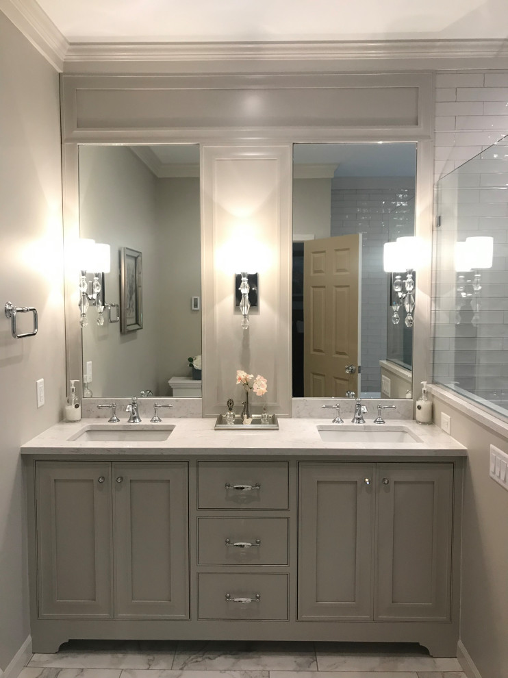 This is an example of a mid-sized traditional master bathroom in San Francisco with shaker cabinets, grey cabinets, a corner shower, gray tile, subway tile, grey walls, marble floors, an undermount sink, granite benchtops, grey floor, a hinged shower door and grey benchtops.