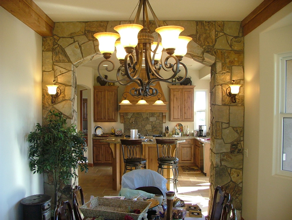 Large mountain style u-shaped porcelain tile eat-in kitchen photo in Phoenix with an undermount sink, raised-panel cabinets, medium tone wood cabinets, granite countertops, brown backsplash, stainless steel appliances, beige walls and an island