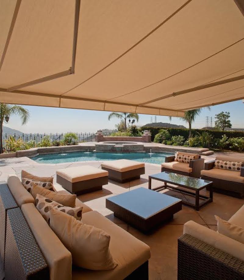 Large beach style backyard patio in Los Angeles with a water feature, stamped concrete and a gazebo/cabana.