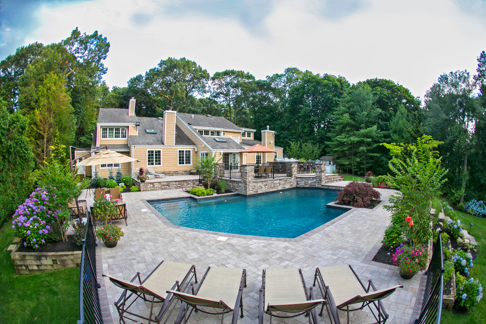 Design ideas for a traditional backyard custom-shaped pool in New York.