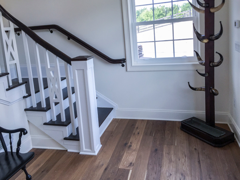 Design ideas for a small country wood l-shaped staircase in DC Metro with wood risers and wood railing.