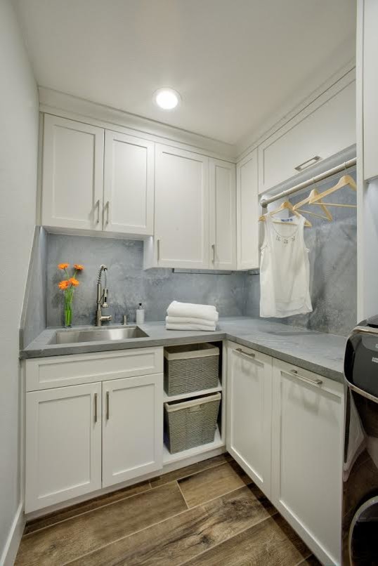 This is an example of a mid-sized traditional l-shaped utility room in Sacramento with an undermount sink, shaker cabinets, white cabinets, concrete benchtops, brown walls, dark hardwood floors, a side-by-side washer and dryer, brown floor and grey benchtop.