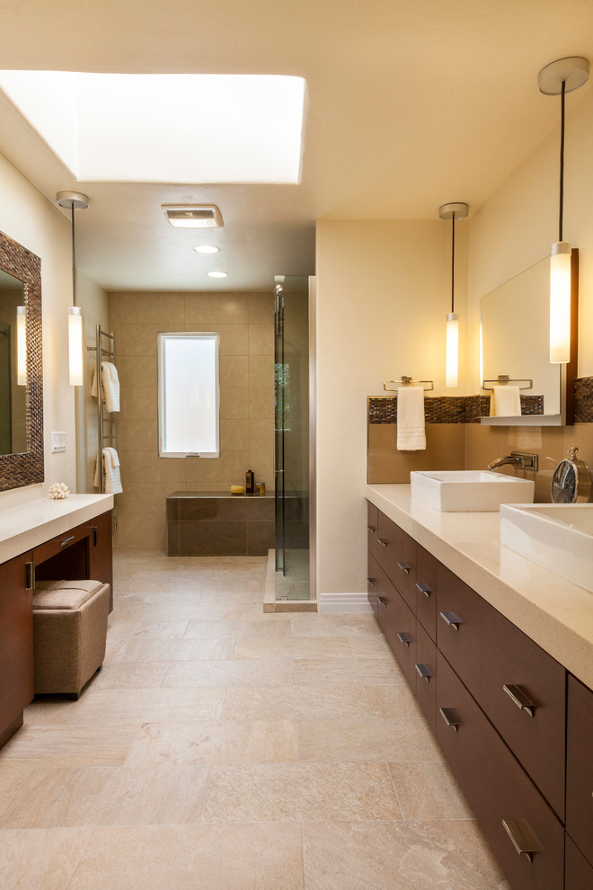 Mid-sized contemporary master bathroom in San Diego with a vessel sink, flat-panel cabinets, dark wood cabinets, recycled glass benchtops, an alcove shower, a two-piece toilet, beige tile, porcelain tile, beige walls and porcelain floors.