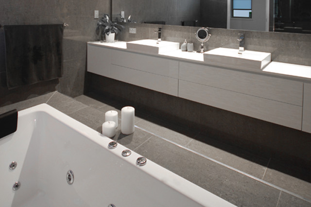 Large modern master bathroom in Brisbane with flat-panel cabinets, white cabinets, a drop-in tub, a double shower and engineered quartz benchtops.