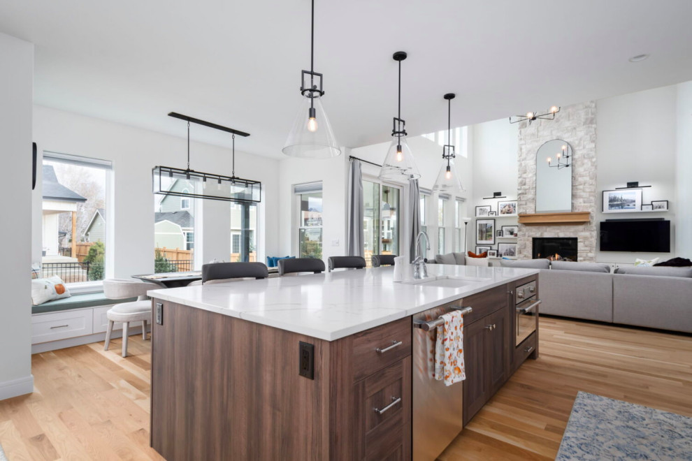 Open concept kitchen - large transitional l-shaped medium tone wood floor, brown floor and coffered ceiling open concept kitchen idea in Austin with an undermount sink, beaded inset cabinets, white cabinets, quartz countertops, white backsplash, quartz backsplash, stainless steel appliances, an island and white countertops