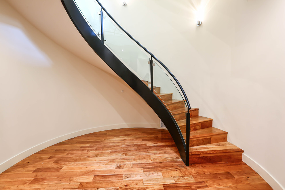 Inspiration for an expansive contemporary wood floating staircase in San Francisco with wood risers and glass railing.