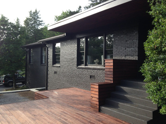 Inspiration for a large transitional one-storey brick black exterior in Nashville.