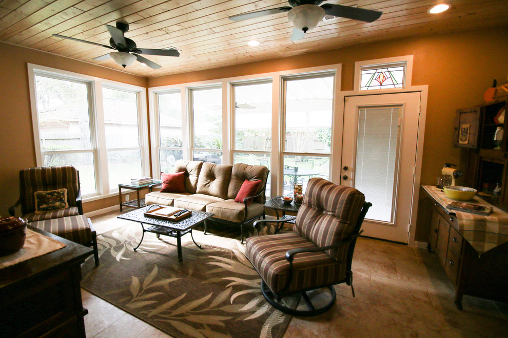 This is an example of a mid-sized traditional sunroom in Houston with a standard fireplace and ceramic floors.