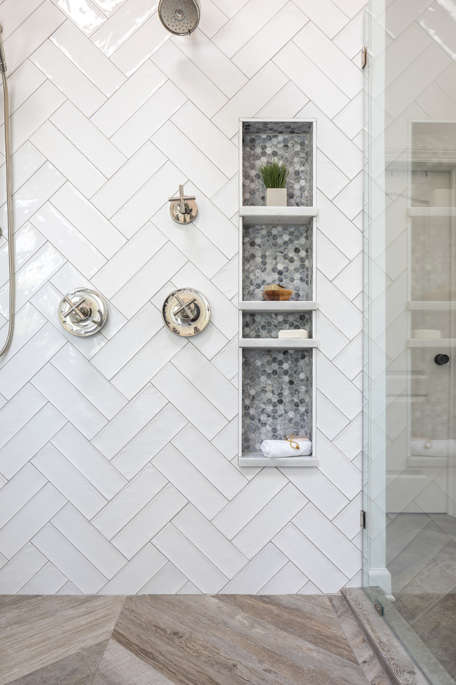 Inspiration for a mid-sized cottage master white tile and ceramic tile porcelain tile and brown floor freestanding bathtub remodel in Raleigh with recessed-panel cabinets, white cabinets, a two-piece toilet, white walls, an undermount sink, marble countertops, a hinged shower door and white countertops