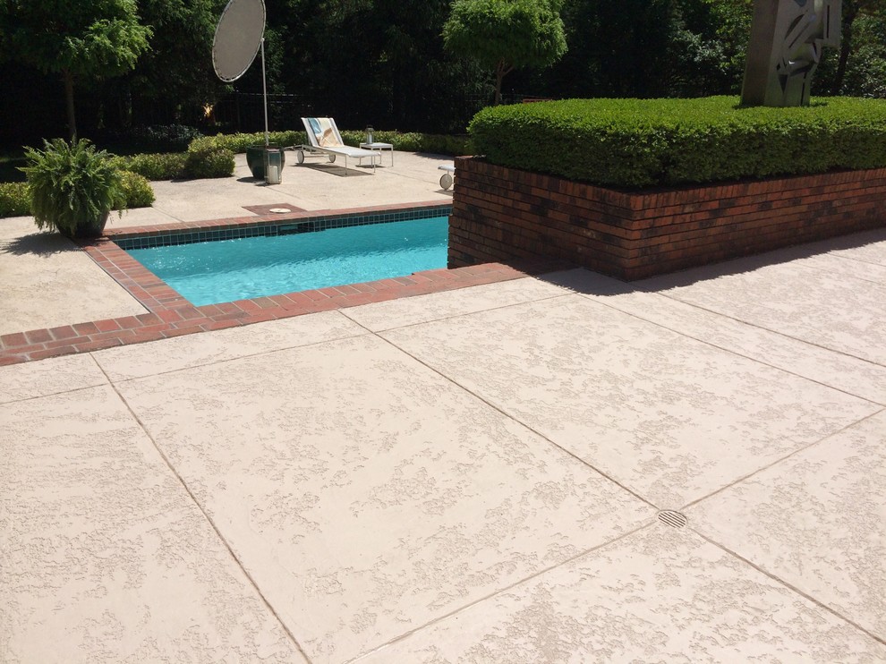 Photo of a mid-sized traditional backyard rectangular lap pool in St Louis with stamped concrete.