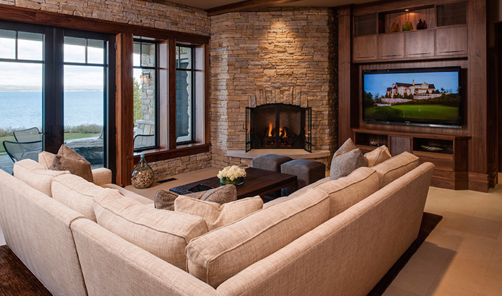Large traditional open concept living room in Other with a corner fireplace, a stone fireplace surround, a built-in media wall, multi-coloured walls and beige floor.