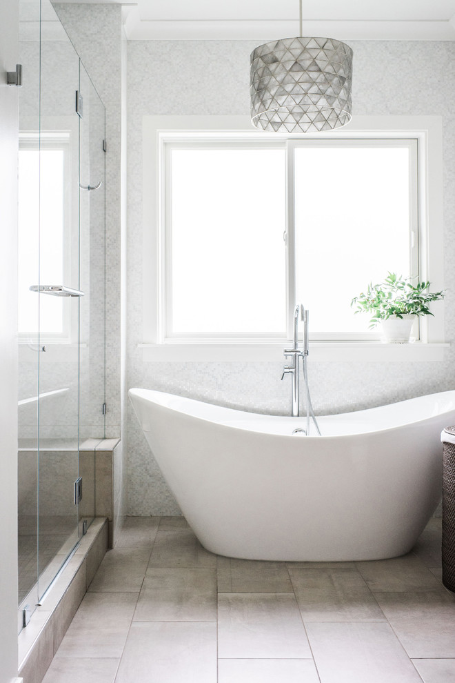 Photo of a transitional master bathroom in San Francisco with a freestanding tub, grey walls, beige floor, an alcove shower and a hinged shower door.