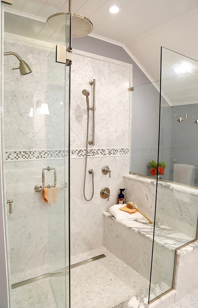 Corner shower - mid-sized transitional master white tile and marble tile marble floor and white floor corner shower idea with raised-panel cabinets, white cabinets, a one-piece toilet, gray walls, an undermount sink, marble countertops and a hinged shower door