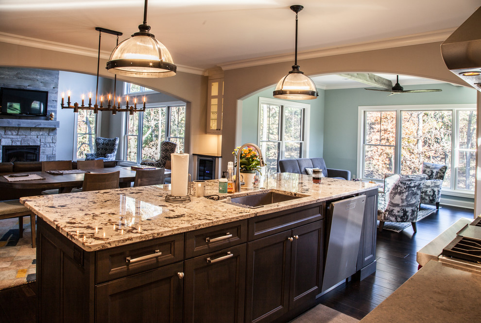 Inspiration for a transitional dark wood floor and brown floor open concept kitchen remodel with an undermount sink, shaker cabinets, white cabinets, granite countertops, beige backsplash, subway tile backsplash, stainless steel appliances and an island