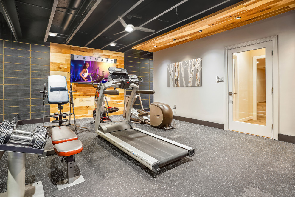 Inspiration for a medium sized urban multi-use home gym in DC Metro with grey walls, grey floors, exposed beams and a feature wall.