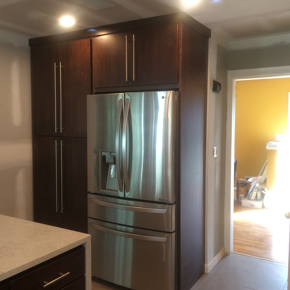 Minimalist l-shaped ceramic tile eat-in kitchen photo with an undermount sink, flat-panel cabinets, dark wood cabinets, marble countertops, multicolored backsplash, matchstick tile backsplash, stainless steel appliances and an island