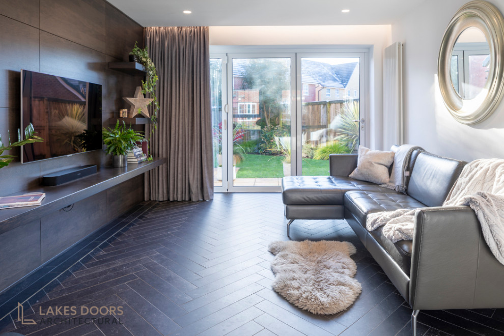 Inspiration for a small modern enclosed living room with white walls, porcelain flooring, no fireplace, a wall mounted tv and black floors.