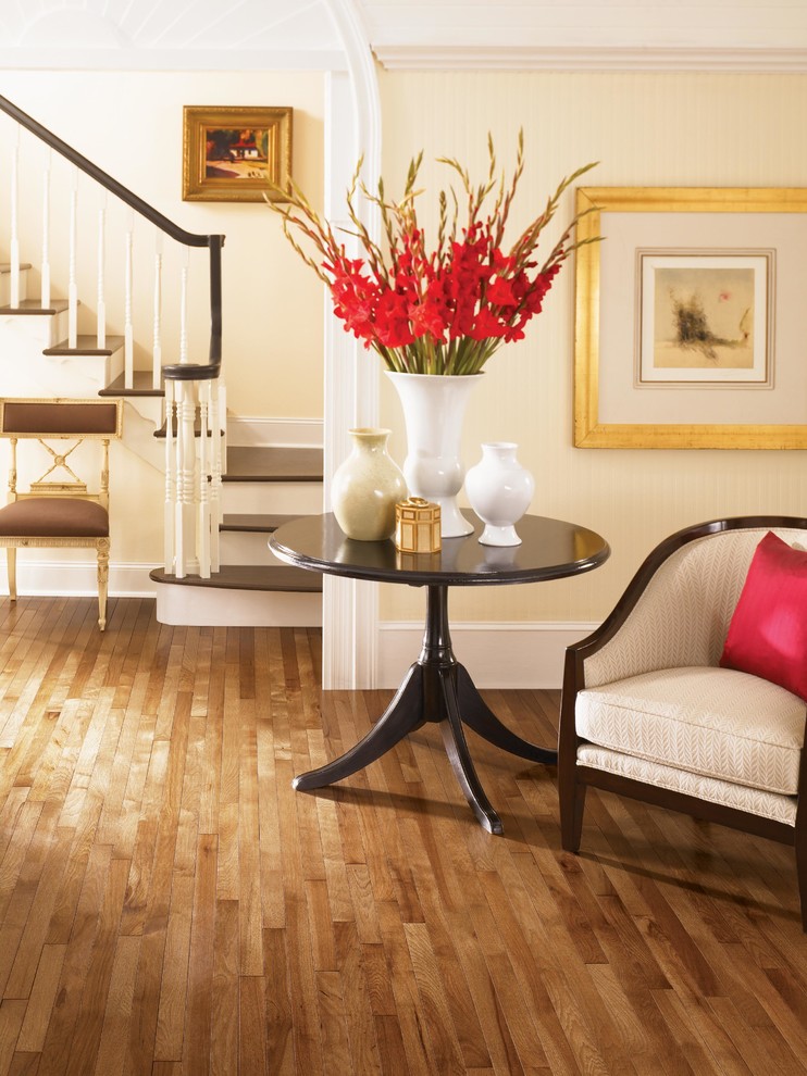 Inspiration for a mid-sized transitional light wood floor entryway remodel with beige walls