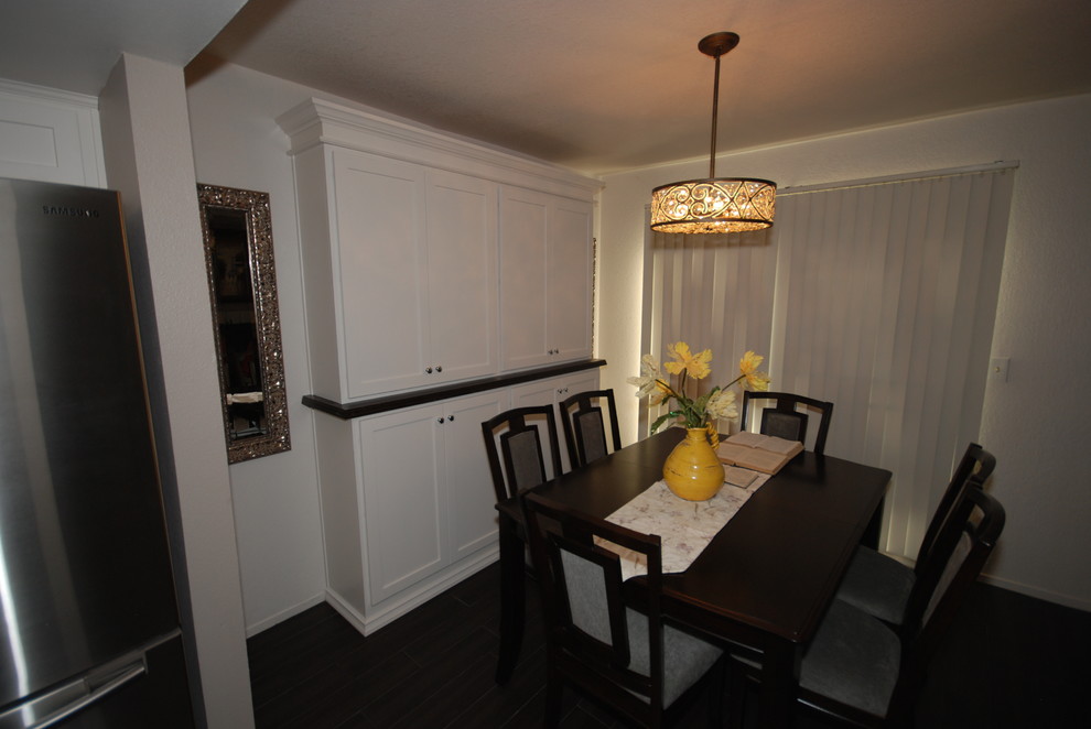 Example of a small transitional u-shaped porcelain tile eat-in kitchen design with a farmhouse sink, shaker cabinets, white cabinets, quartz countertops, white backsplash, subway tile backsplash, stainless steel appliances and gray walls