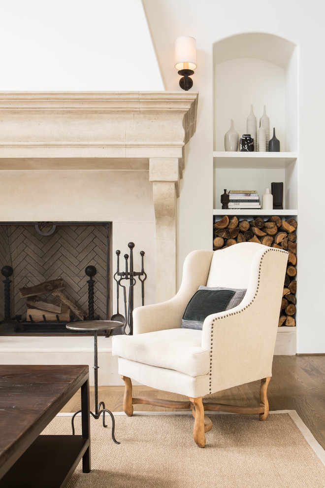 This is an example of a mid-sized mediterranean formal open concept living room in San Francisco with beige walls, medium hardwood floors, a standard fireplace, a plaster fireplace surround and no tv.