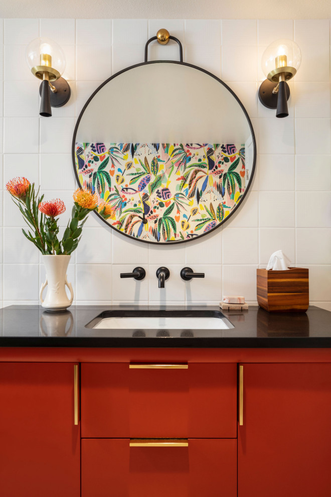 Bathroom - mid-sized eclectic kids' white tile and porcelain tile terrazzo floor, multicolored floor, single-sink and wallpaper bathroom idea in Denver with flat-panel cabinets, red cabinets, a one-piece toilet, multicolored walls, an undermount sink, quartz countertops, black countertops, a niche and a freestanding vanity