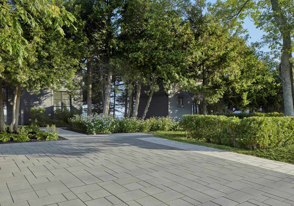 Inspiration for a modern front yard driveway in Montreal with a garden path and concrete pavers.