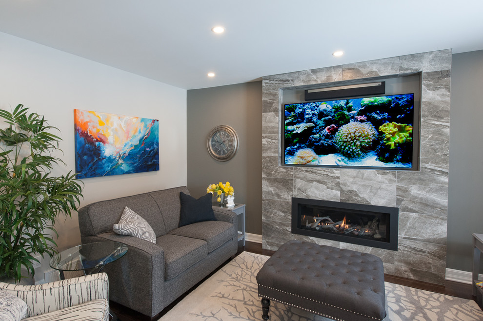 This is an example of a small transitional open concept family room in Ottawa with grey walls, dark hardwood floors, a ribbon fireplace, a tile fireplace surround and a wall-mounted tv.