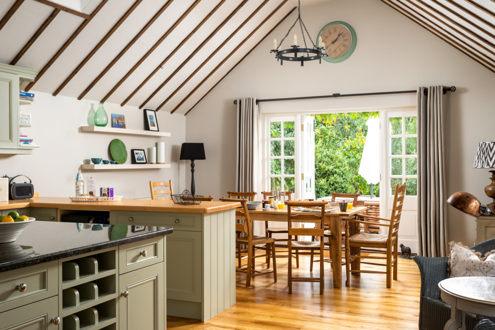 Inspiration for a large country open plan dining in Gloucestershire with medium hardwood floors, brown floor and beige walls.