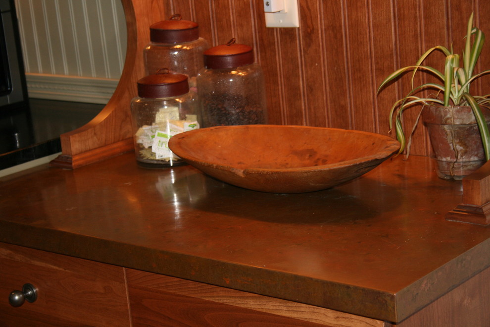 Inspiration for a mid-sized transitional l-shaped medium tone wood floor eat-in kitchen remodel with a farmhouse sink, flat-panel cabinets, medium tone wood cabinets, copper countertops, beige backsplash, stainless steel appliances and no island