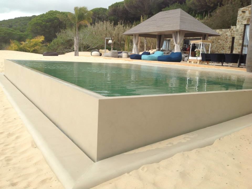 This is an example of a mid-sized mediterranean front yard rectangular lap pool in Barcelona with a pool house.