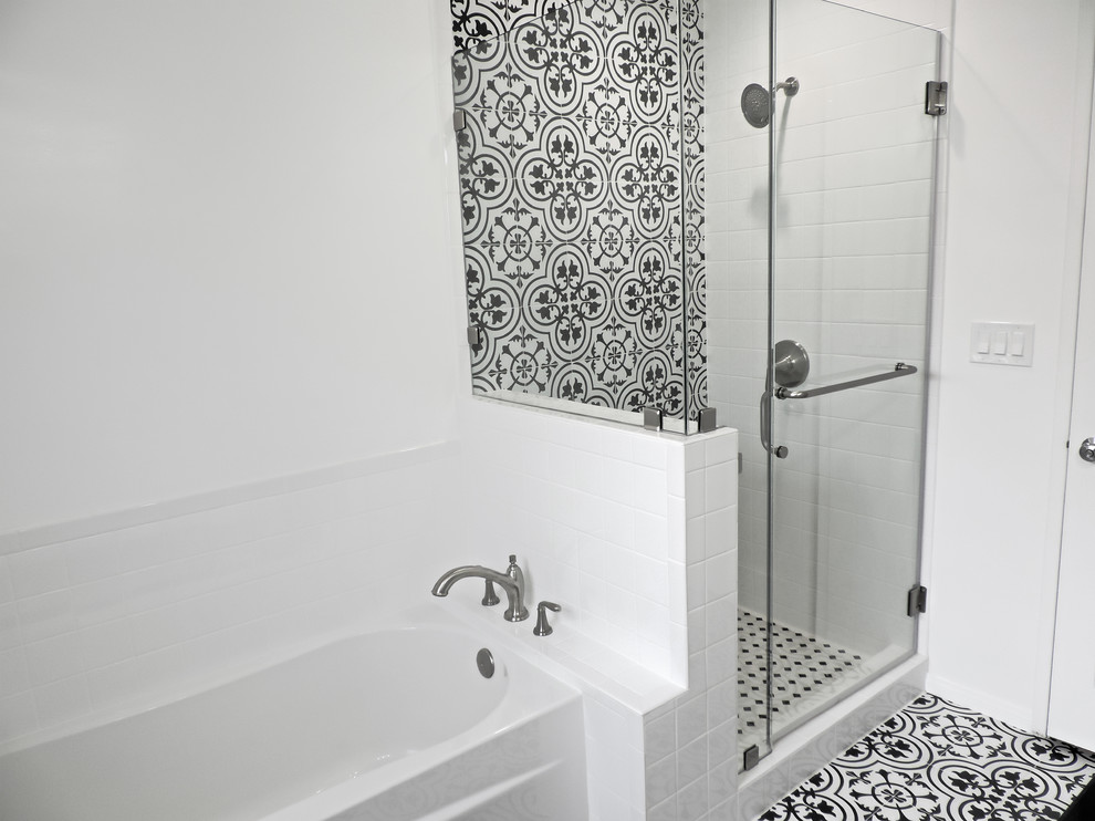 This is an example of a mid-sized master bathroom in Los Angeles with furniture-like cabinets, white cabinets, an alcove tub, an alcove shower, a two-piece toilet, black and white tile, porcelain tile, white walls, porcelain floors, a vessel sink, engineered quartz benchtops, white floor and black benchtops.