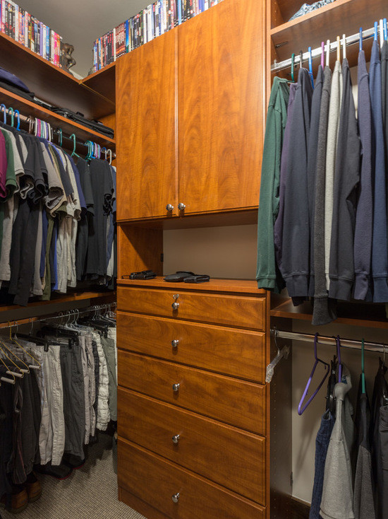 Inspiration for a small transitional gender-neutral walk-in wardrobe in Chicago with flat-panel cabinets, light wood cabinets and carpet.