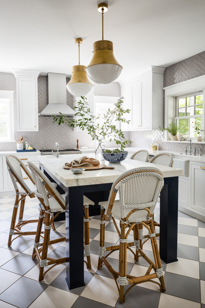 Kitchen - large traditional porcelain tile kitchen idea in DC Metro with a farmhouse sink, shaker cabinets, white cabinets, marble countertops, gray backsplash, stainless steel appliances, an island and white countertops
