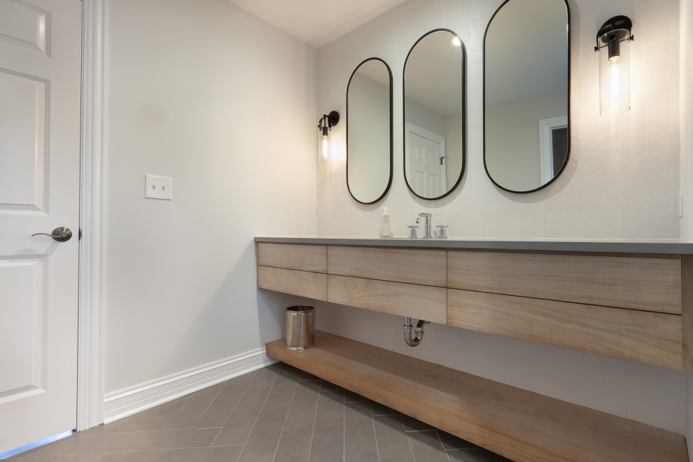 Photo of a large traditional cloakroom in Chicago with flat-panel cabinets, light wood cabinets, white tiles, porcelain tiles, a submerged sink, engineered stone worktops, grey worktops and a floating vanity unit.