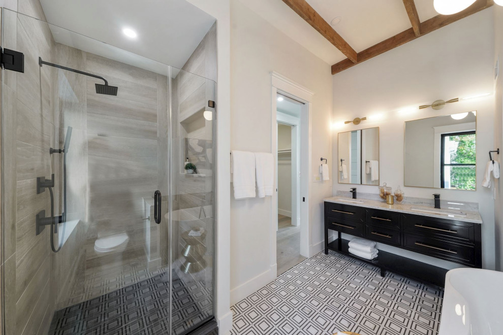 This is an example of a mid-sized contemporary master bathroom in DC Metro with shaker cabinets, black cabinets, a freestanding tub, an alcove shower, a one-piece toilet, white tile, subway tile, an undermount sink, solid surface benchtops, a sliding shower screen, white benchtops, a niche, a double vanity, a built-in vanity and vaulted.