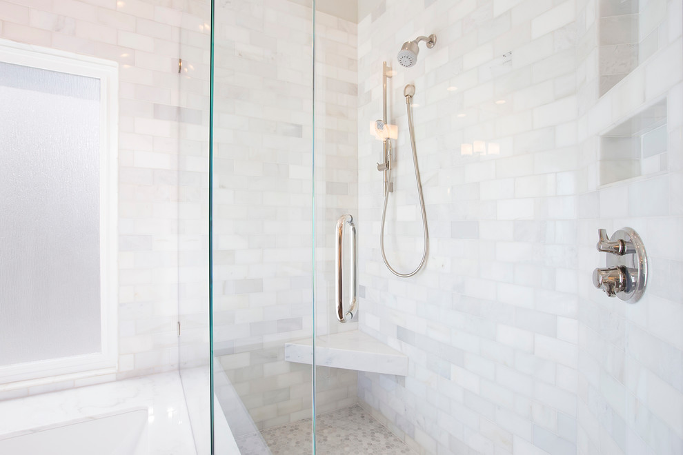 Large traditional master bathroom in San Diego with an undermount sink, raised-panel cabinets, white cabinets, marble benchtops, a drop-in tub, a corner shower, a one-piece toilet, white tile, stone tile, white walls and porcelain floors.