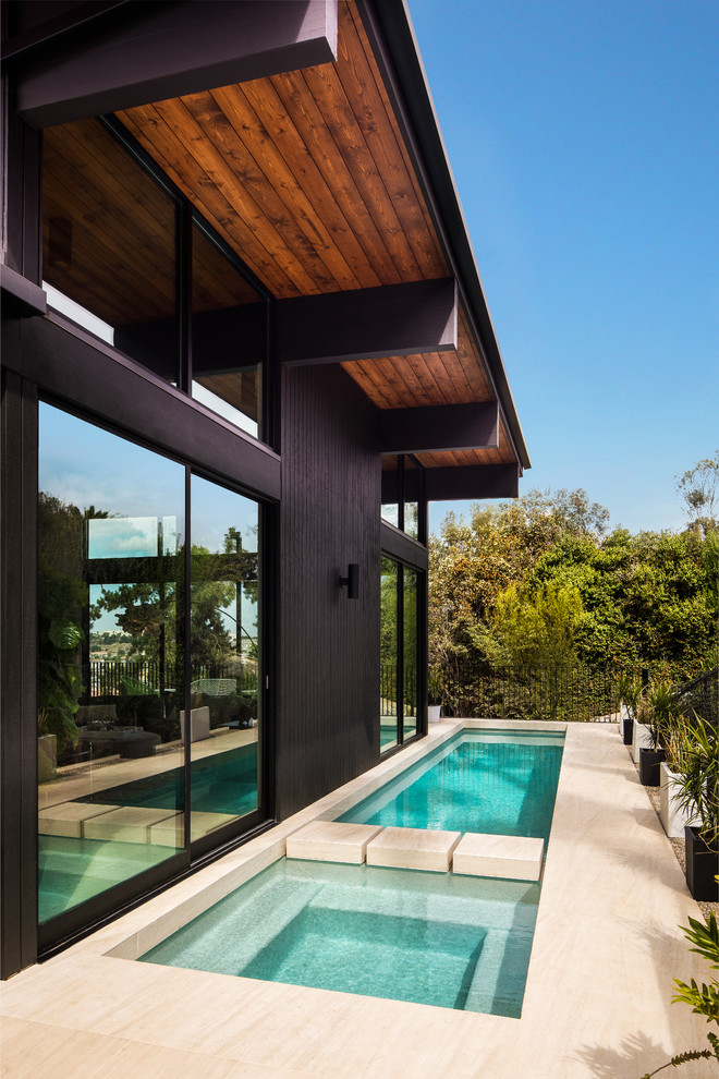 Inspiration for a midcentury rectangular lap pool in San Diego with a hot tub.
