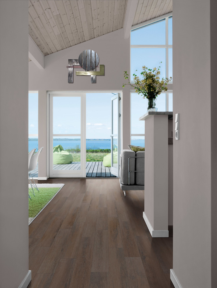 Large beach style hallway in Other with grey walls, porcelain floors and brown floor.