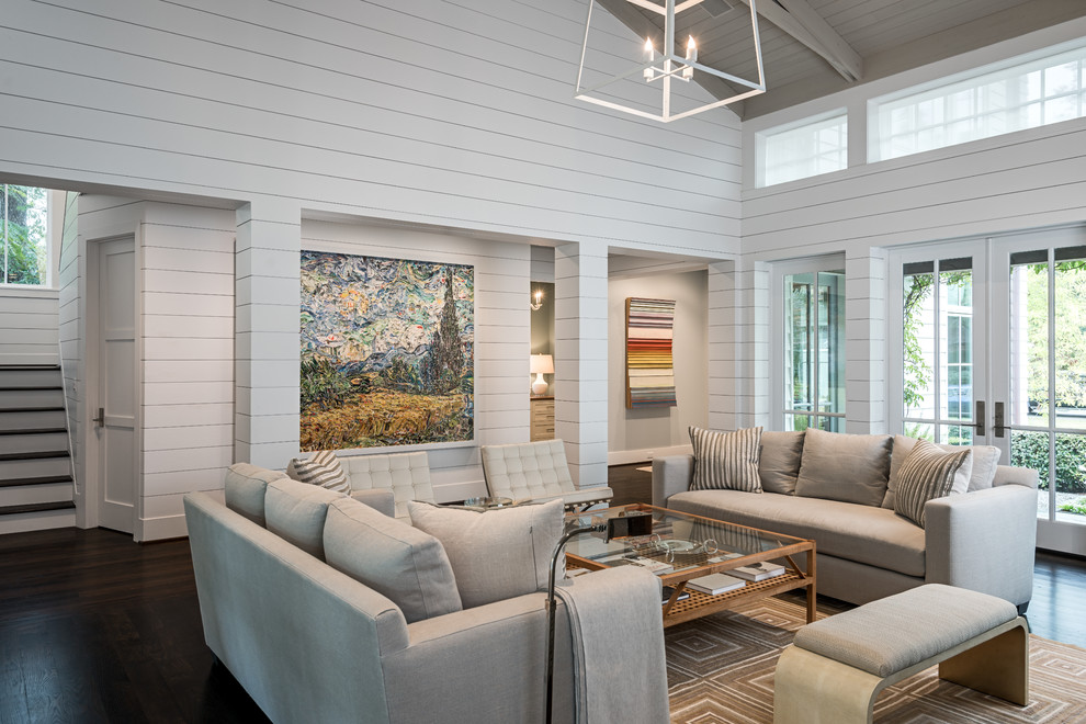 Design ideas for a country open concept living room in Houston with white walls, dark hardwood floors and brown floor.
